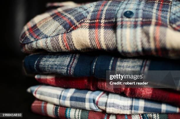 stack of plaid check flannel shirts - embellished shirt stock pictures, royalty-free photos & images