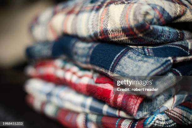 stack of plaid check flannel shirts - embellished shirt stock pictures, royalty-free photos & images