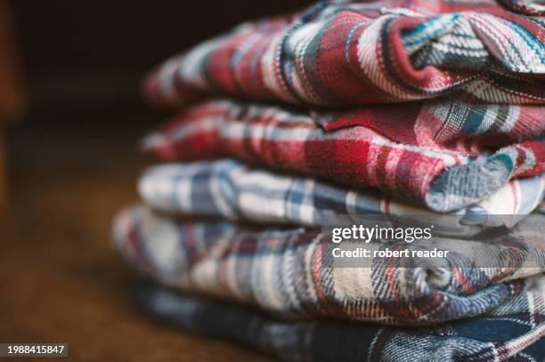 stack of plaid check flannel shirts - embellished shirt stock pictures, royalty-free photos & images