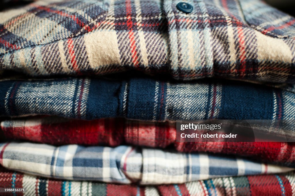 Stack of plaid check flannel shirts