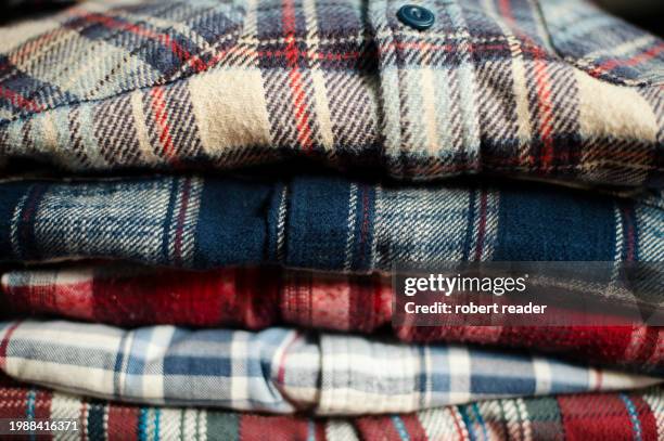 stack of plaid check flannel shirts - embellished shirt stock pictures, royalty-free photos & images