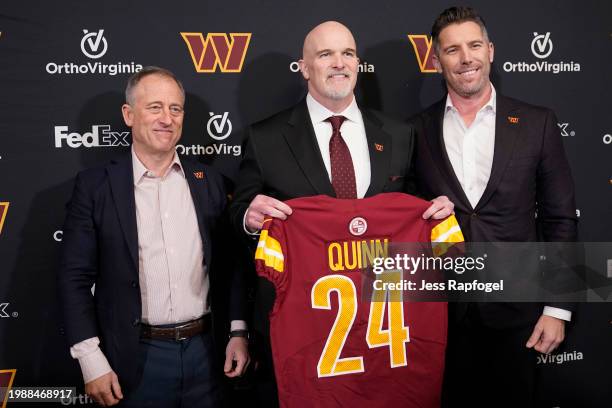 Head coach Dan Quinn of the Washington Commanders poses for a photo with managing partner Josh Harris and general manager Adam Peters following a...