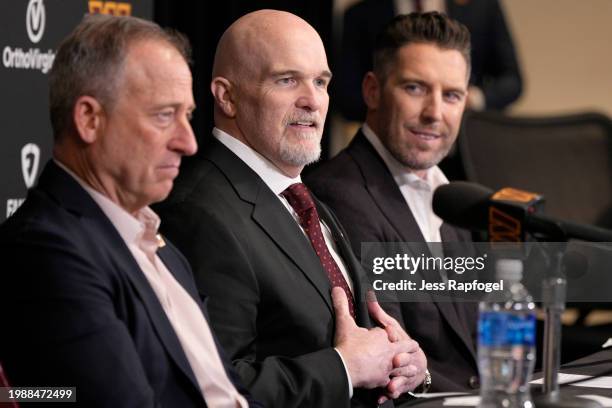 Head coach Dan Quinn of the Washington Commanders speaks during a press conference alongside managing partner Josh Harris, left, and general manager...