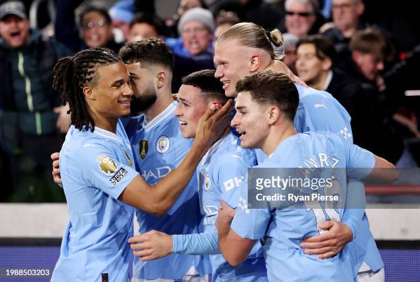 Phil Foden of Manchester City celebrates scoring his team's second goal with teammates during the Premier League match between Brentford FC and...