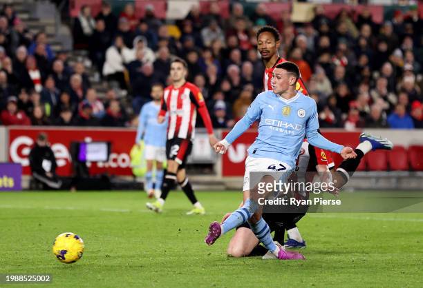 Phil Foden of Manchester City scores his team's third goal, his hat-trick, during the Premier League match between Brentford FC and Manchester City...