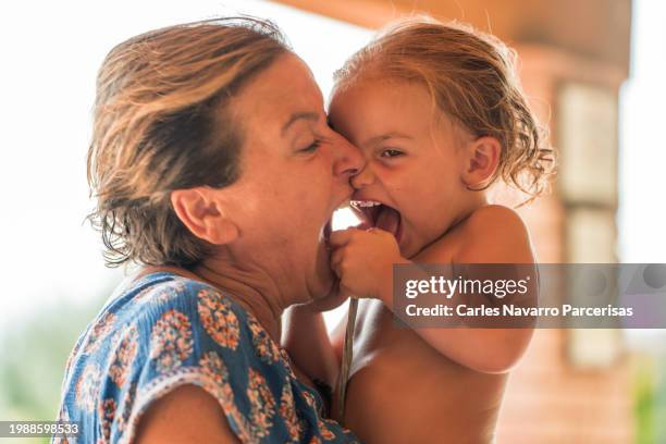 a proud aunt relishing moments of laughter and complicity with her baby niece. - children funny moments stock pictures, royalty-free photos & images