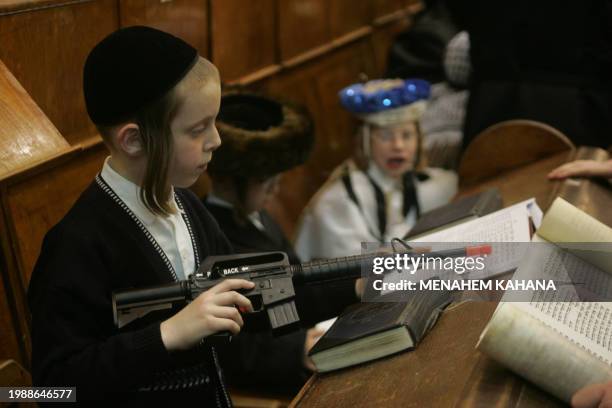 Ultra Orthodox Jews from the Wiznitz Hassidim group reads the Ester scrolls at the synagogue in the Israeli town of Beni Brak near Tel Aviv 13 March...