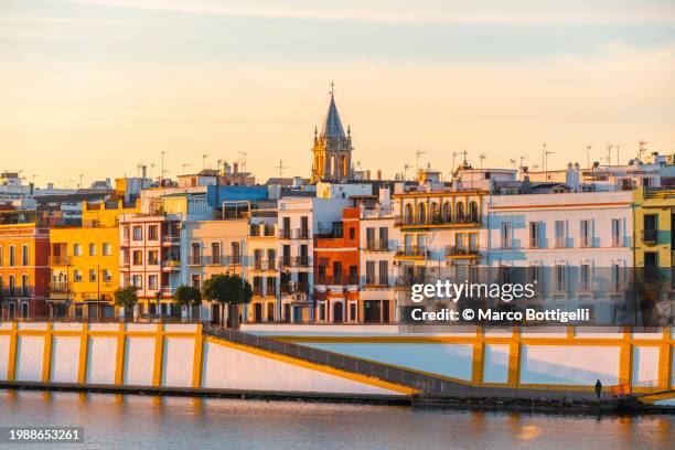 cityscape along the riverbanks, seville, spain. - sevilha imagens e fotografias de stock
