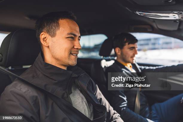 driver transporting a business man on a crowd sourced taxi - ziga plahutar stock pictures, royalty-free photos & images