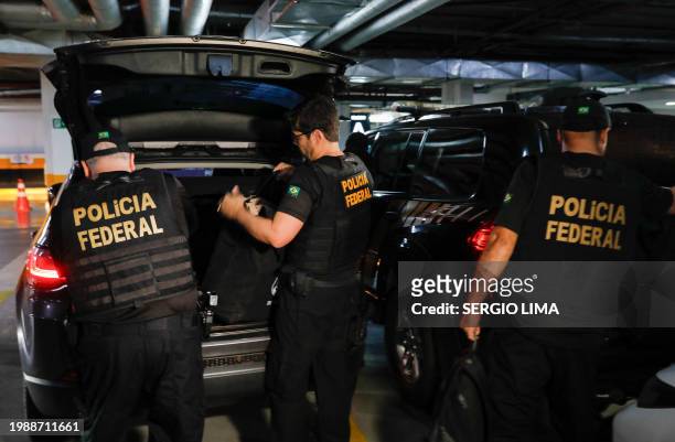 Federal police officers leave the headquarters of the Liberal Party during an operation targeting some of former President Jair Bolsonaro's top aides...
