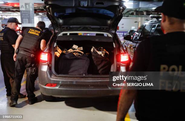 Federal police officers leave the headquarters of the Liberal Party during an operation targeting some of former President Jair Bolsonaro's top aides...