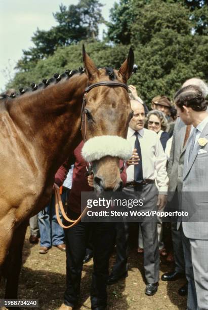 Prince Charles with the Irish champion Thoroughbred steeplechaser Red Rum, who won the Grand National three years in a row, circa 1980.