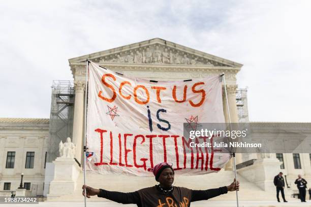 Protester outside the U.S. Supreme Court on February 8, 2024 in Washington, DC. The court heard oral arguments in a case on whether or not former...