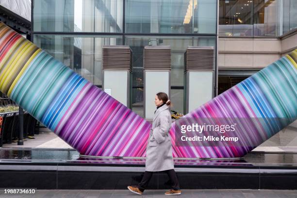 People interacting with the geometric public artwork 'Click Your Heels Together Three Times' by artist Adam Nathaniel Furman on the exterior of the...