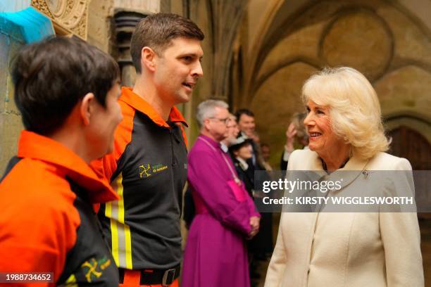 Britain's Queen Camilla meets with members of the Wiltshire Air Ambulance upon her arrival to attend a Musical Evening at Salisbury Cathedral, in...