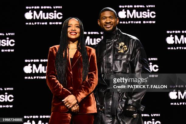 Apple Music's Nadeska Alexis and US singer and songwriter Usher pose for photos during a press conference ahead of Super Bowl LVIII in Las Vegas,...