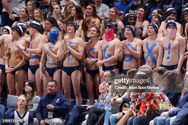 Xavier Musketeers swim team members cheer from the student section during a college basketball game against the Villanova Wildcats at Cintas Center...