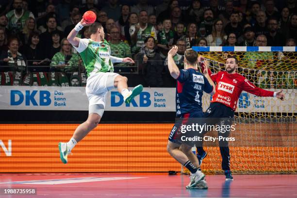 Mijajlo Marsenic of Fuechse Berlin, Johannes Golla and Benjamin Buric of SG Flensburg-Handewitt during the Handball Bundesliga match between Fuechse...