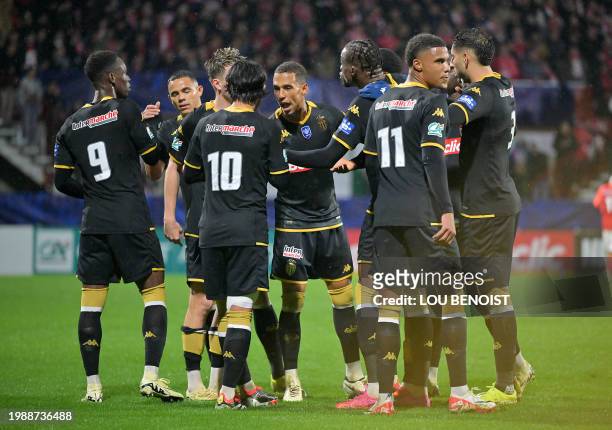 Monaco's players celebrate after scoring their first goal during the French Cup last sixteen football match between FC Rouen 1899 and AS Monaco at...