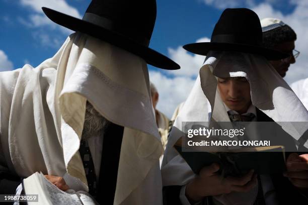 Orthodox Jews cover their heads with prayer shawls as they take part in the Blessing of the Priests ceremony or 'Birkat Cohanim,' at the Western Wall...