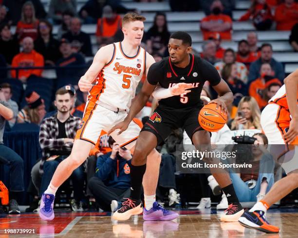 Louisvilie Cardinals Forward Brandon Huntley-Harfield dribbles the ball against Syracuse Orange Guard Justin Taylor during the second half of the...