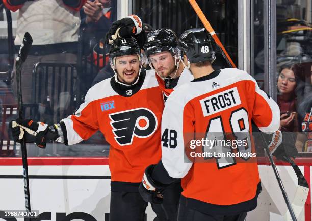 Travis Konecny of the Philadelphia Flyers celebrates his first period goal against the Winnipeg Jets with Joel Farabee and Morgan Frost at the Wells...