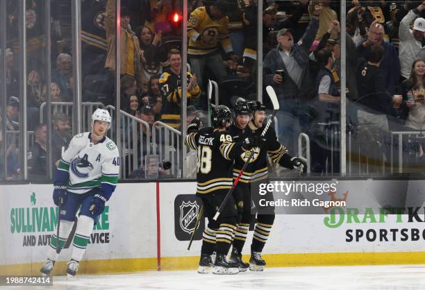 Pavel Zacha of the Boston Bruins celebrates his goal against the Vancouver Canucks during the second period with his teammates David Pastrnak and...