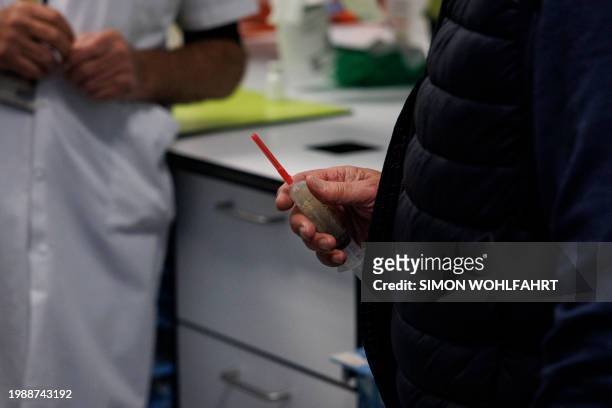 Doctor Yves de Locht holds the lethal syringe at a hospital in Belgium, on February 1, 2024. Lydie Imhoff, a 43 year-old French citizen suffering...