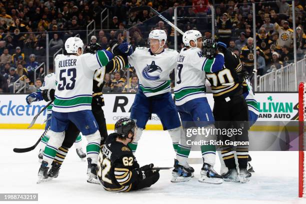 Nikita Zadorov of the Vancouver Canucks shoves Oskar Steen of the Boston Bruins during the third period at the TD Garden on February 8, 2024 in...