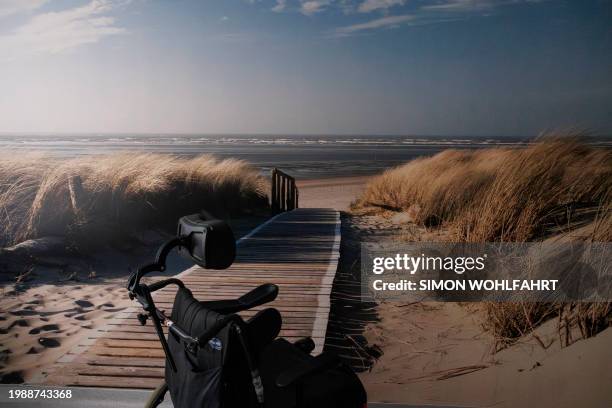 The empty wheelchair of Lydie Imhoff is seen next to a wall of the hospital room that depicts a printed view of the sea after Imhoff underwent...
