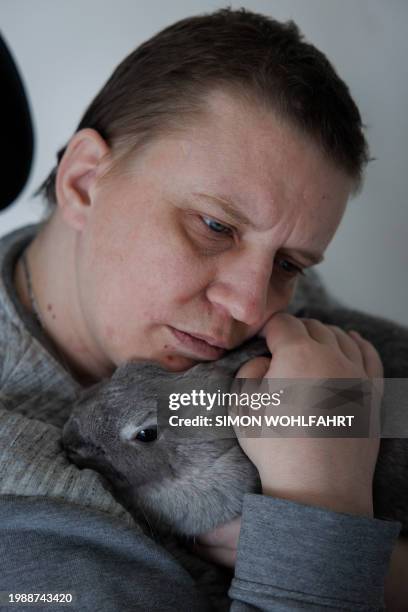 Lydie Imhoff sits in her wheelchair hugging her rabbit "Lucky" while spending her last day in her empty home in Besançon, France, on January 30,...