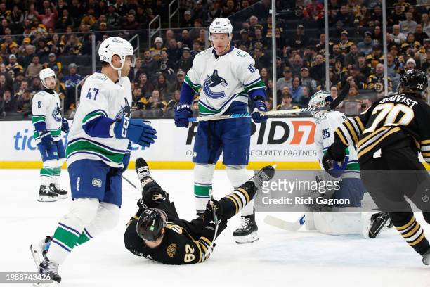 Nikita Zadorov of the Vancouver Canucks shoves Oskar Steen of the Boston Bruins during the third period at the TD Garden on February 8, 2024 in...