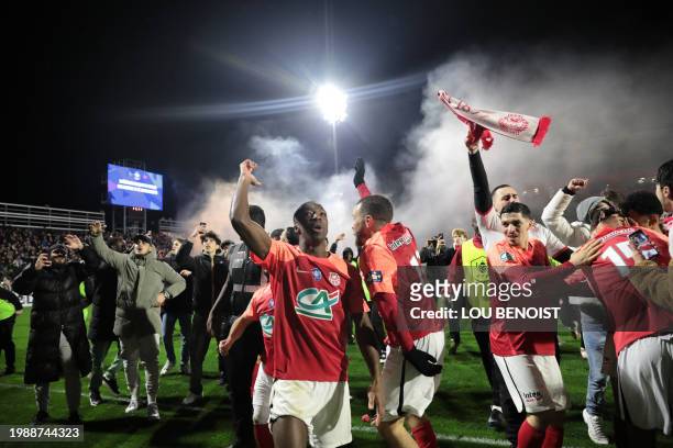 Rouen's players celebrate after winning the French Cup last sixteen football match between FC Rouen 1899 and AS Monaco at the Robert-Diochon Stadium...