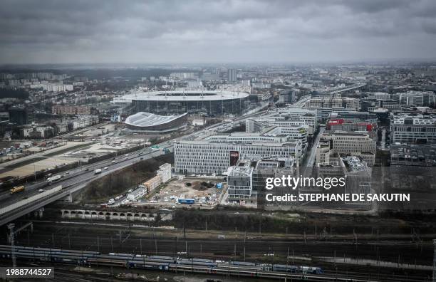 This photograph taken on February 7, 2024 shows the Aquatic Olympic Center swimming pool and the 'Stade de France' stadium from the Pleyel Tower,...