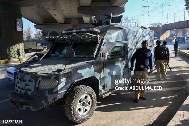 Police stand guard in Peshawar on February 9 a day after Pakistan's national elections. Independent candidates linked to jailed former prime minister...