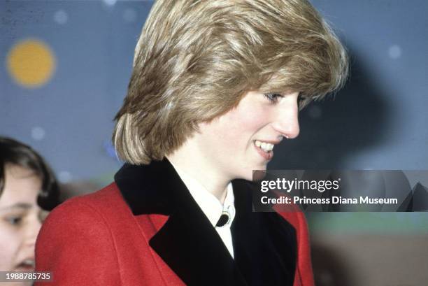 Close-up view of Diana, Princess of Wales , wearing a Catherine Walker coat, smiles during her visit to the Charlie Chaplin Adventure Playground for...