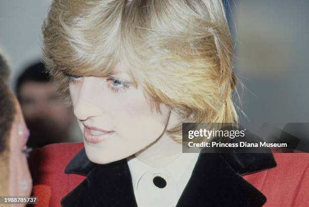 Close-up view of Diana, Princess of Wales , wearing a Catherine Walker coat, talks to the children at the Charlie Chaplin Adventure Playground for...