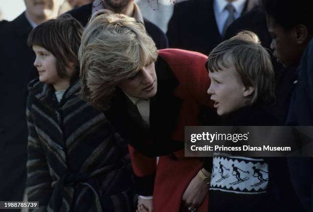 Diana, Princess of Wales , wearing a Catherine Walker coat, talks to an unidentified child during her visit at the Charlie Chaplin Adventure...