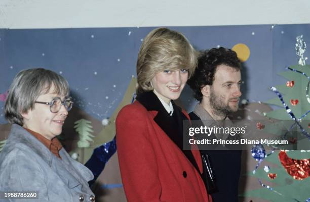 Diana, Princess of Wales , wearing a Catherine Walker coat, smiles during her visit to the Charlie Chaplin Adventure Playground for handicapped...