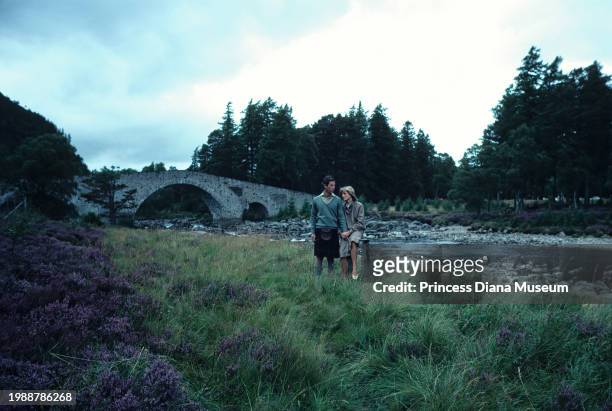 Charles III of the United Kingdom and Diana, Princess of Wales , wearing a suit designed by Bill Pashley, pose for a portrait along the banks of the...