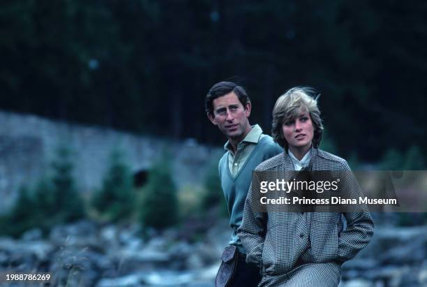 Charles III of the United Kingdom and Diana, Princess of Wales , wearing a suit designed by Bill Pashley, enjoy the banks of the river Dee on the...