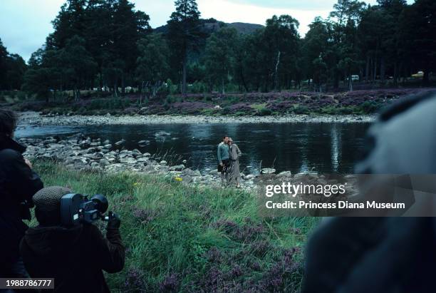 Charles III of the United Kingdom and Diana, Princess of Wales , wearing a suit designed by Bill Pashley, pose for a portrait along the banks of the...