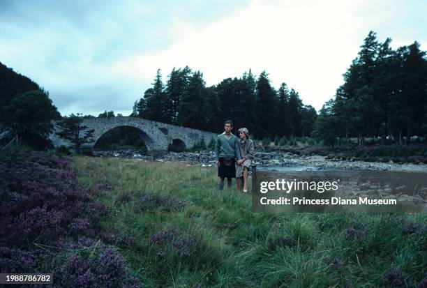 Charles III of the United Kingdom and Diana, Princess of Wales , wearing a suit designed by Bill Pashley, pose for a portrait along the banks of the...