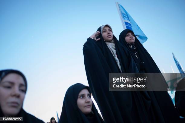 Veiled young Iranian woman is saluting while performing in a ceremony at the holy mosque of Jamkaran on the outskirts of the holy city of Qom, 145 km...