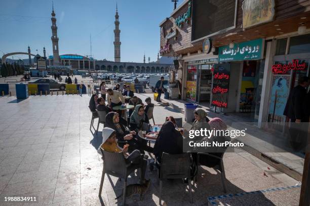 Pilgrims are sitting at an outdoor cafe near the holy mosque of Jamkaran on the outskirts of the holy city of Qom, 145 km south of Tehran, in Qom,...