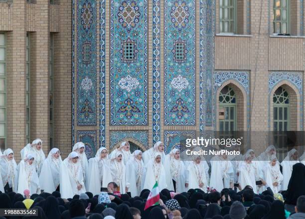 Veiled Iranian schoolgirls are saluting while performing in a ceremony at the holy mosque of Jamkaran on the outskirts of the holy city of Qom, 145...