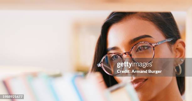 student, bookshelf and woman learning in library, studying or knowledge in college closeup. education, face and indian person at bookstore in glasses at university for scholarship, info or research - philosophy book stock pictures, royalty-free photos & images