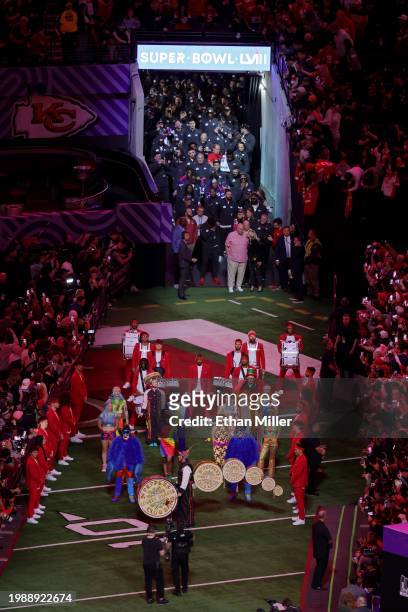Head coach Andy Reid of the Kansas City Chiefs and his wife Tammy Reid lead the team onto the field during Super Bowl LVIII Opening Night at...