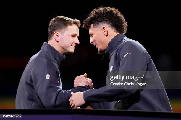 Brock Purdy of the San Francisco 49ers and Patrick Mahomes of the Kansas City Chiefs meet on stage during Super Bowl LVIII Opening Night at Allegiant...