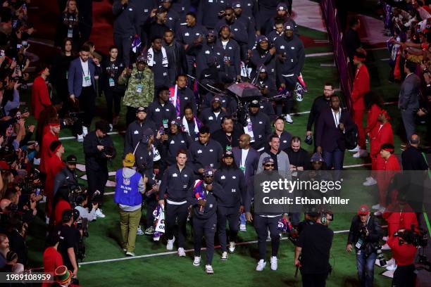 The San Francisco 49ers walk across the field during Super Bowl LVIII Opening Night at Allegiant Stadium on February 05, 2024 in Las Vegas, Nevada.